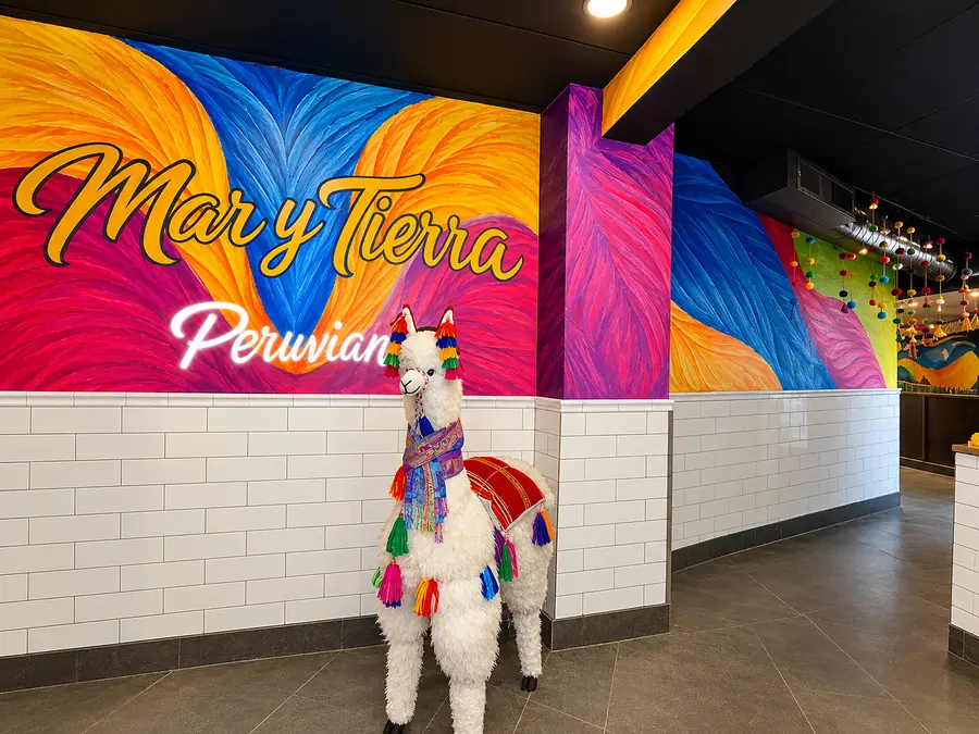 Mar y Tierra Peruvian mural with a llama